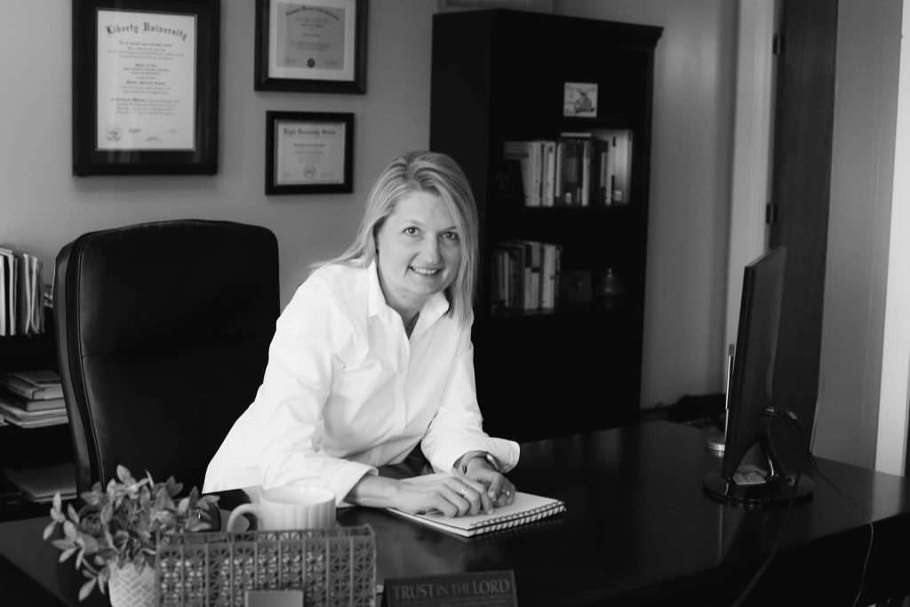 Michelle McLerran sitting at her desk at Strategic Christian Solutions in Warsaw, Missouri